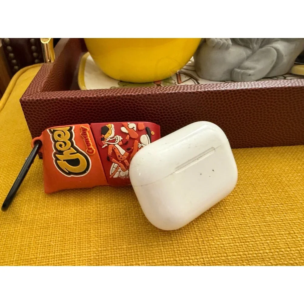 AirPods charger and half of a Cheetos case